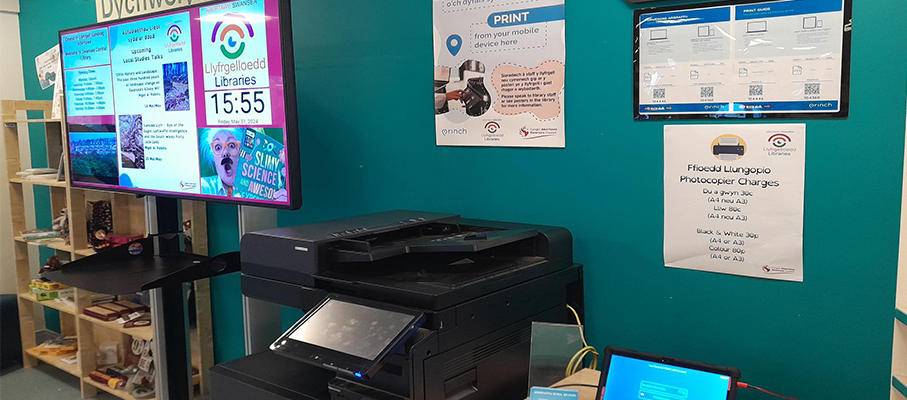 Swansea printer with miltiple Princh guide posters put up on the wall.